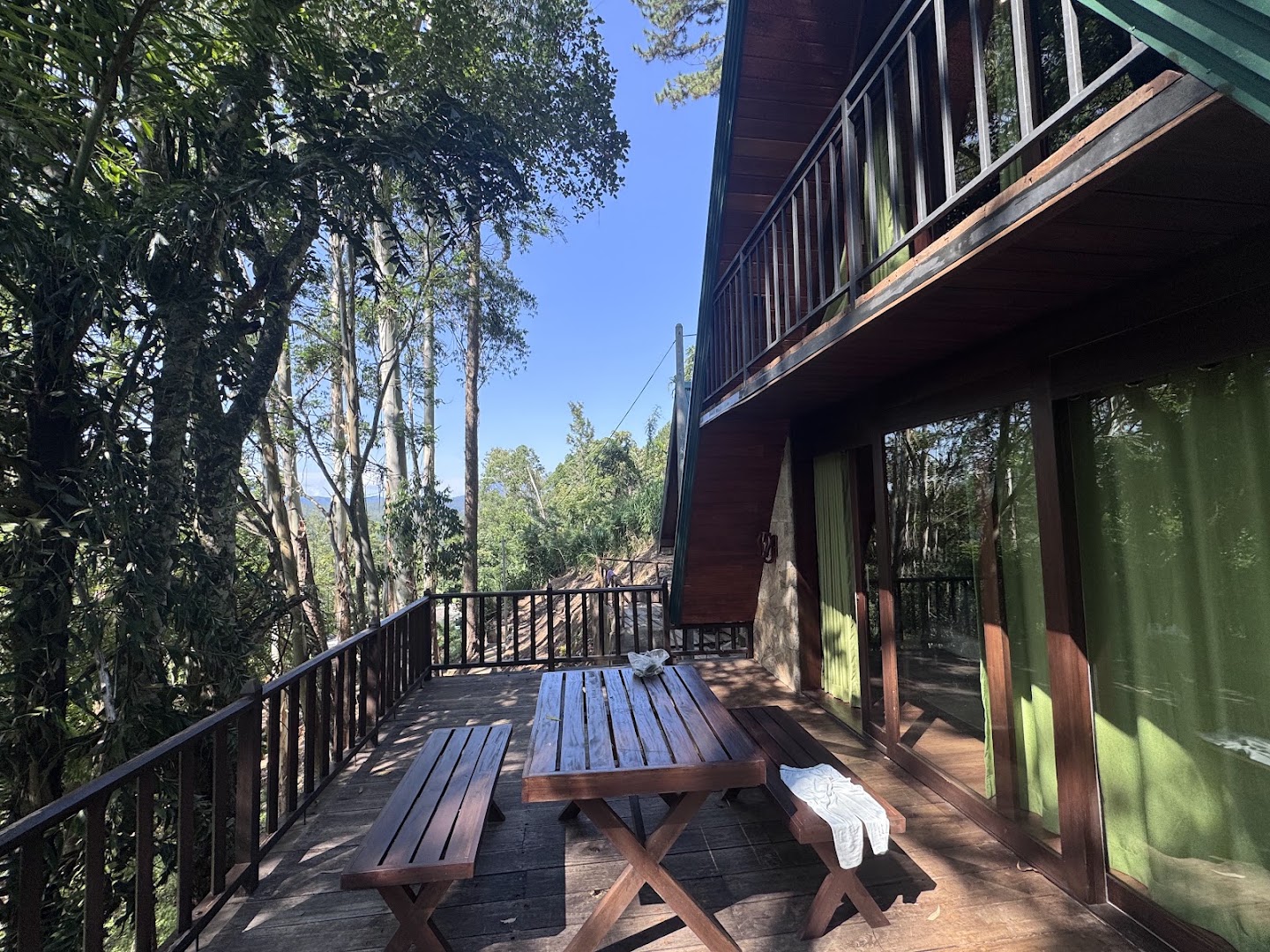 Timber deck with picnic table beside the cabana and surrounded by trees